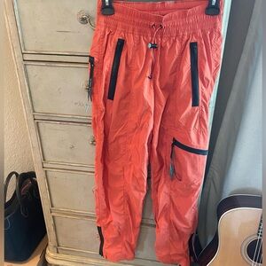 REI Co-Op brand orange leather pants